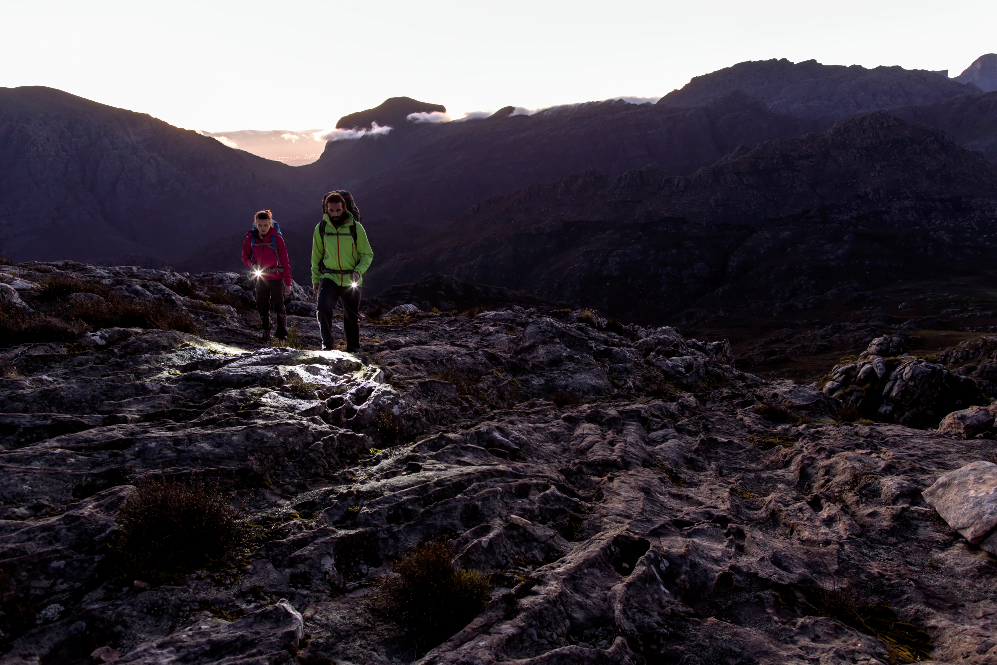 Two people with headlamps hiking