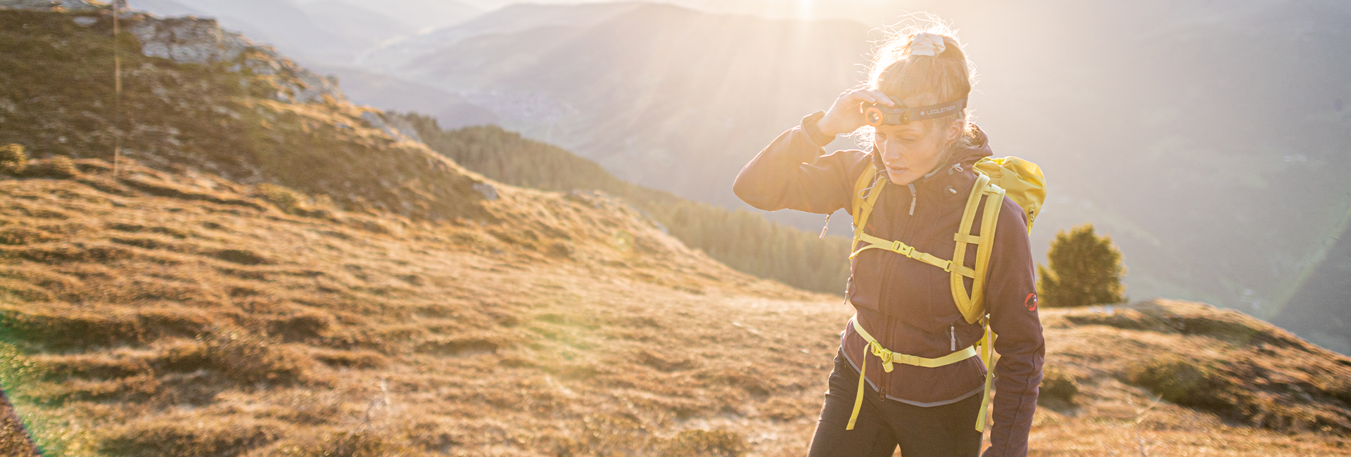 A hiking woman with a headlamp