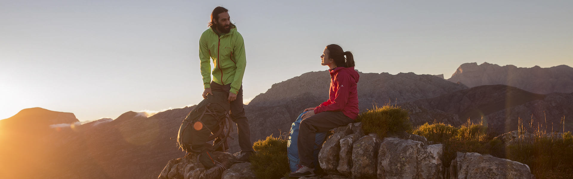 A man and a woman are hiking