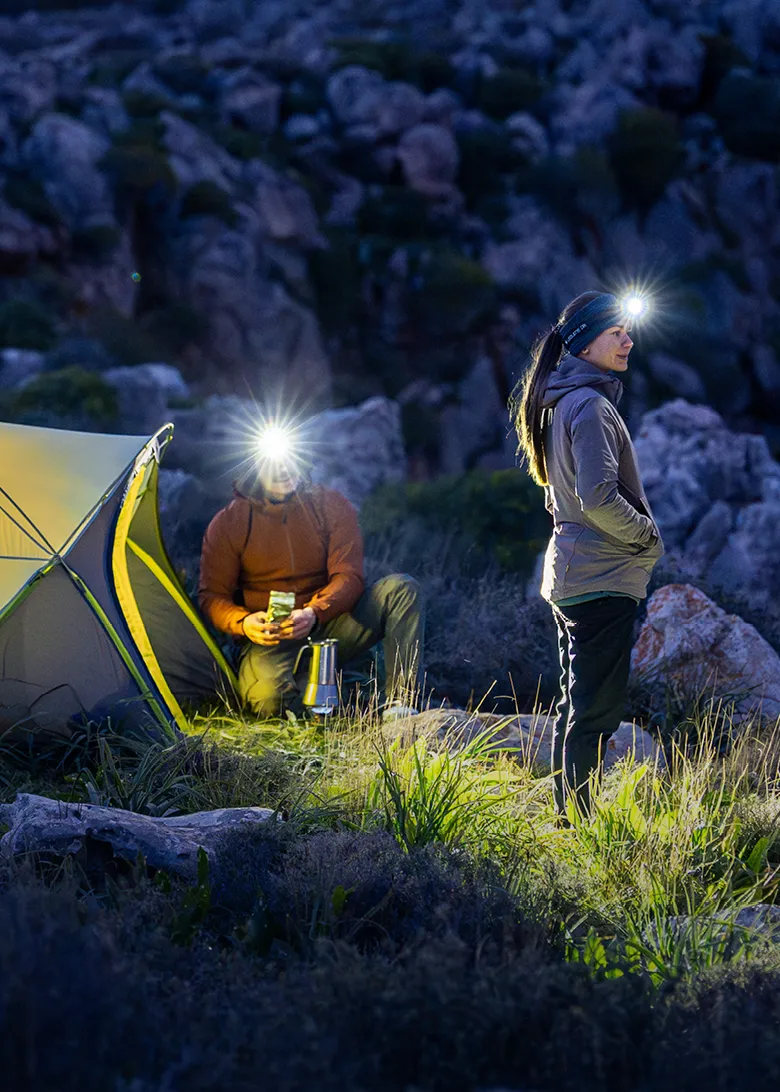 Person wearing a Ledlenser headlamp at dusk